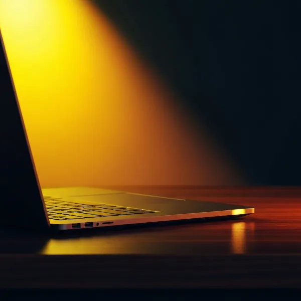 Sleek laptop on dark walnut desk